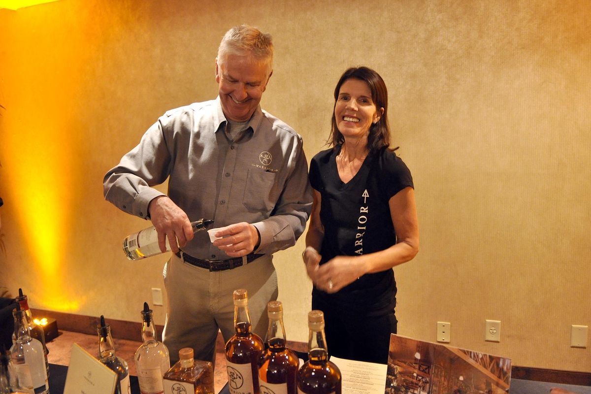 Rich and Mary Clemson, proprietors of Warrior Liquor Distilling, pour samples of their products at the Spokane Culinary Arts Guild Awards on Tuesday night at Max at Mirabeau in Spokane Valley. (Adriana Janovich / The Spokesman-Review)