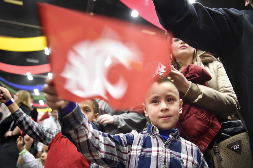 Diego Favela, 5, cheers with his sister Angela, standing behind him, during the 19th annual Hyundai Sun Bowl Fan Fiesta on Friday  at Judson F. Williams Convention Center in El Paso, Texas. (Tyler Tjomsland / The Spokesman-Review)