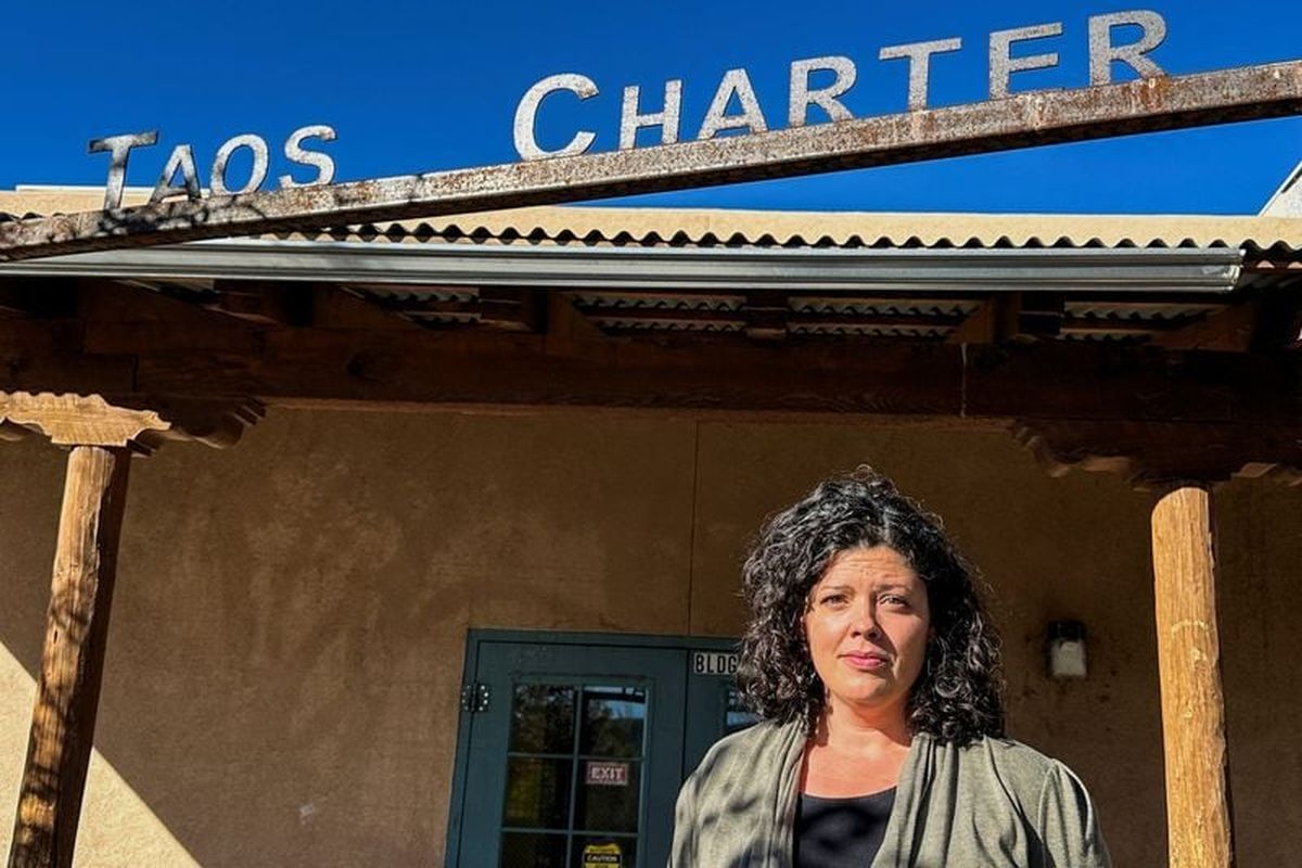 Allyson O’Brien, a special education teacher who stands to save about $12,000 a year in child care costs after New Mexico became the first U.S. state to offer free universal child care, poses for a photograph on Thursday outside of the Taos Charter School, in Taos, N.M.  (Andrew Hay)