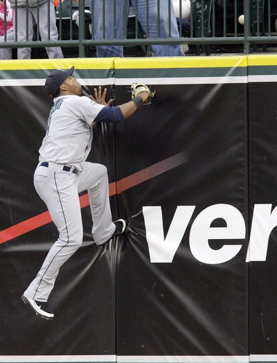 Seattle Mariners right fielder Carlos Peguero watches as the ball clears the wall for a two-run home run by Detroit Tigers designated hitter Victor Martinez during the fourth inning of  game played Friday, June 10, 2011, in Detroit. (Carlos Osorio / Associated Press)
