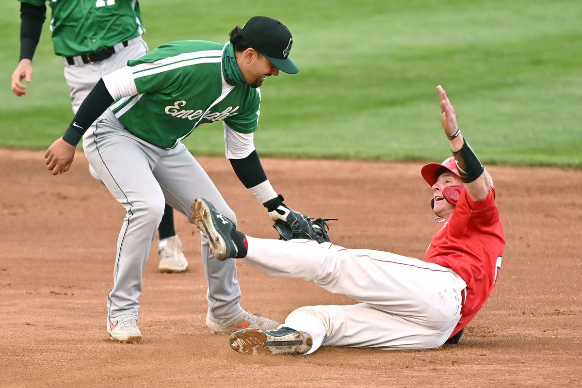 Spokane Indians catcher Willie MacIver (20) is tagged out on a steal attempt by Eugene Emeralds infielder Carter Aldrete (7) during a High A West baseball game on Sat. May 8, 2021 at Avista Stadium in Spokane WA. (James Snook-for Spokesman Review)  (James Snook)