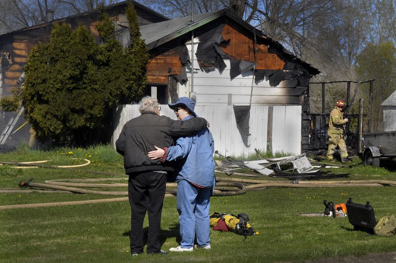 Jean Davenport ( right ) is comforted by a friend after returning home to find her house at 16725 E. Valleway destroyed by fire Friday May 1, 2009. CHRISTOPHER ANDERSON The Spokesman-Review (Christopher Anderson / The Spokesman-Review)
