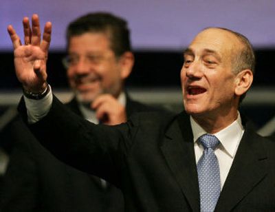 
Ehud Olmert, acting Israeli prime minister and Kadima Party leader, waves to supporters  outside Jerusalem on  Wednesday. 
 (Associated Press / The Spokesman-Review)