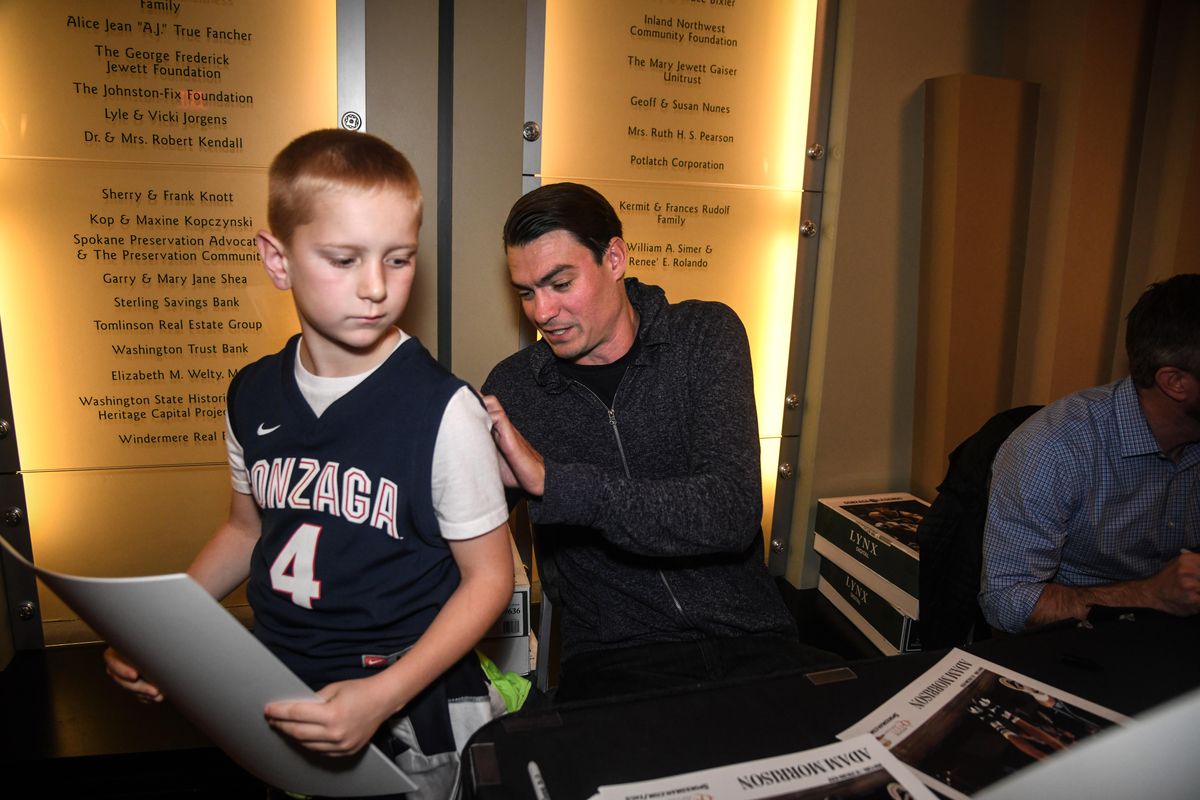Former GU star Adam Morrison signs an autograph for Landon Brunner, 9, after the Gonzaga Legends event, Monday, Nov. 5, 2018. (Dan Pelle / The Spokesman-Review)