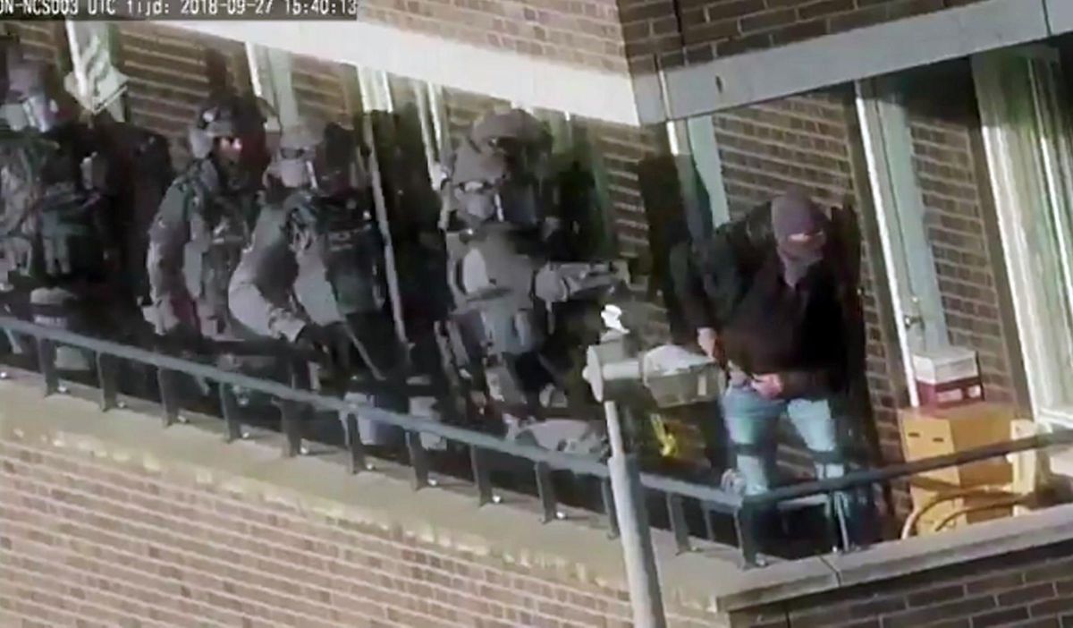 In this image made from video provided by the Netherlands Police, armed police prepare for an operation in a residential area in Arnhem, Netherlands, Thursday, Sept. 27, 2018. Seven men were arrested Thursday in the Netherlands on suspicion of plotting a large-scale extremist attack that Dutch prosecutors said they think was foiled following a months-long investigation. The national prosecutor’s office said in a statement that heavily armed police arrested the men in the towns of Arnhem, about 100 kilometers (62 miles) south of Amsterdam, and Weert in the southern Netherlands close to the borders of Germany and Belgium. (Associated Press)