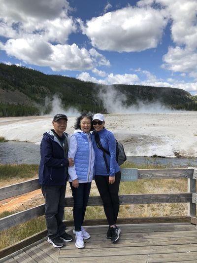 Weiwei Raugust (right) poses with her parents in Yellowstone National Park, when they came to visit this summer in August. Raugust's parents live in Wuhan and got back one day before Chinese officials shut the city down. (Courtesy of Weiwei Raugust / Courtesy of Weiwei Raugust)