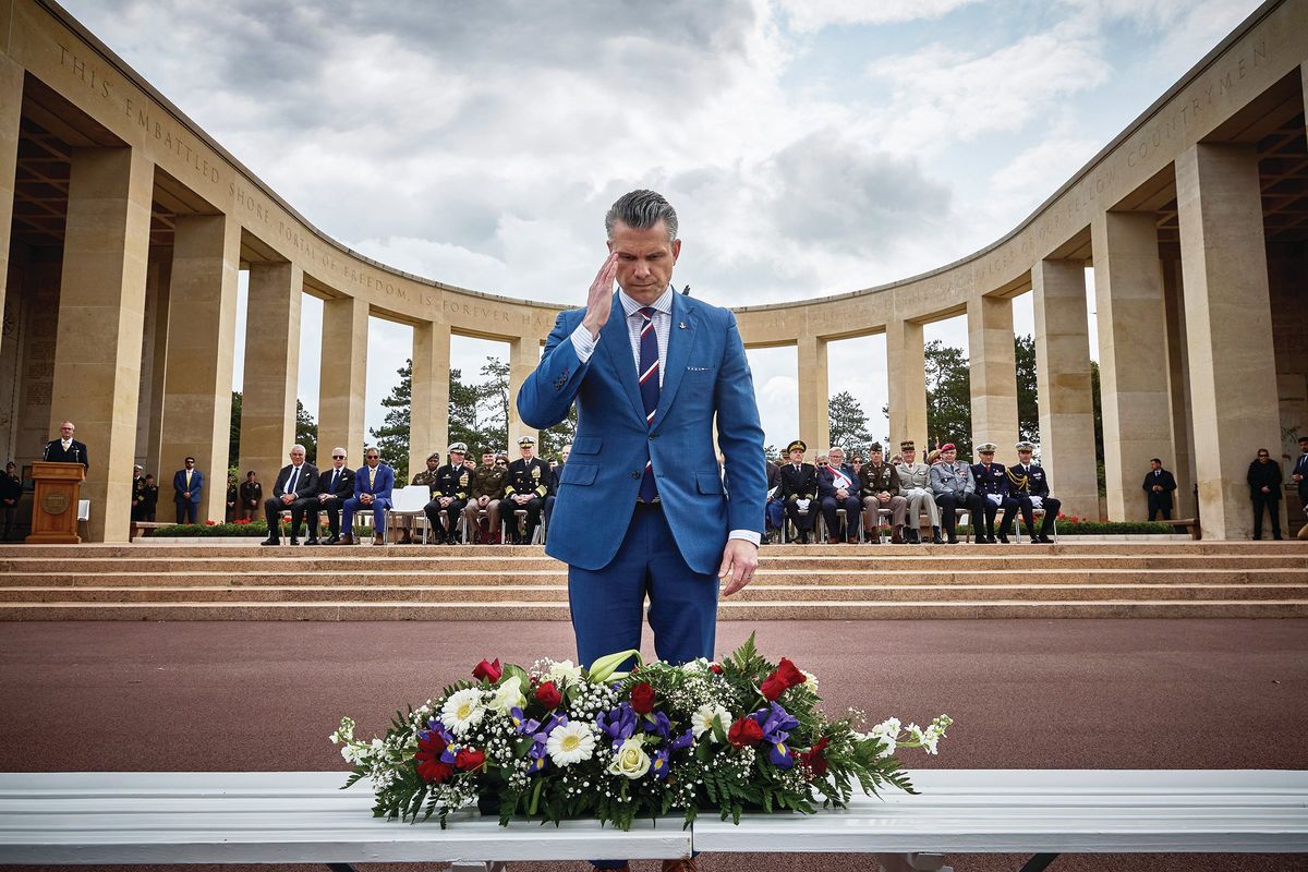 U.S. Secretary of Defence Pete Hegseth salutes as he lays a wreath during a ceremony Friday at the Normandy American Cemetery to mark the 81st anniversary of the D-Day landings during World War II in Colleville-sur-Mer, France. (Kiran Ridley)