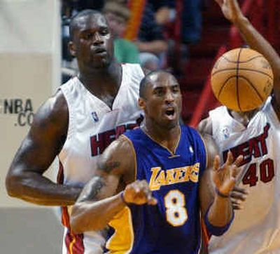 
Los Angeles' Kobe Bryant (8) passes the ball as Miami's Shaquille O'Neal, left, and Udonis Haslem (40) defend.
 (Associated Press / The Spokesman-Review)