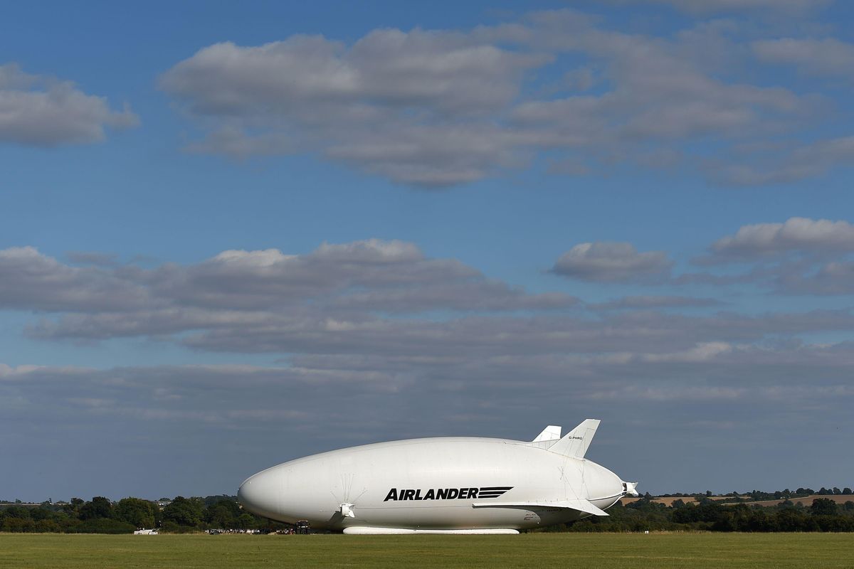 The Airlander 10, part plane, part airship, goes through pre-flight checks at Cardington airfield in Bedfordshire, England, Sunday Aug. 14, 2016. The makers of a blimp-shaped, helium-filled airship billed as the world’s biggest aircraft postponed its maiden flight at the last minute on Sunday. (Joe Giddens / Associated Press)