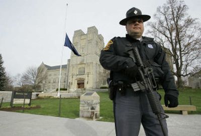 
A Virginia state trooper carries an assault rifle  after a security scare at Virginia Tech on Wednesday, two days after the deadly shootings on the Blacksburg, Va., campus. Colleges and universities are reviewing alert systems and other security measures in the wake of the shooting deaths Monday. 
 (Associated Press / The Spokesman-Review)