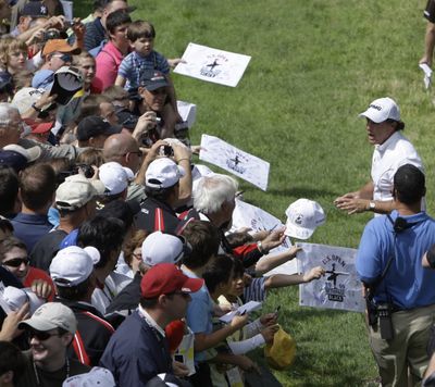 Phil Mickelson greets spectators with autographs after Wednesday’s practice round.  (Associated Press / The Spokesman-Review)