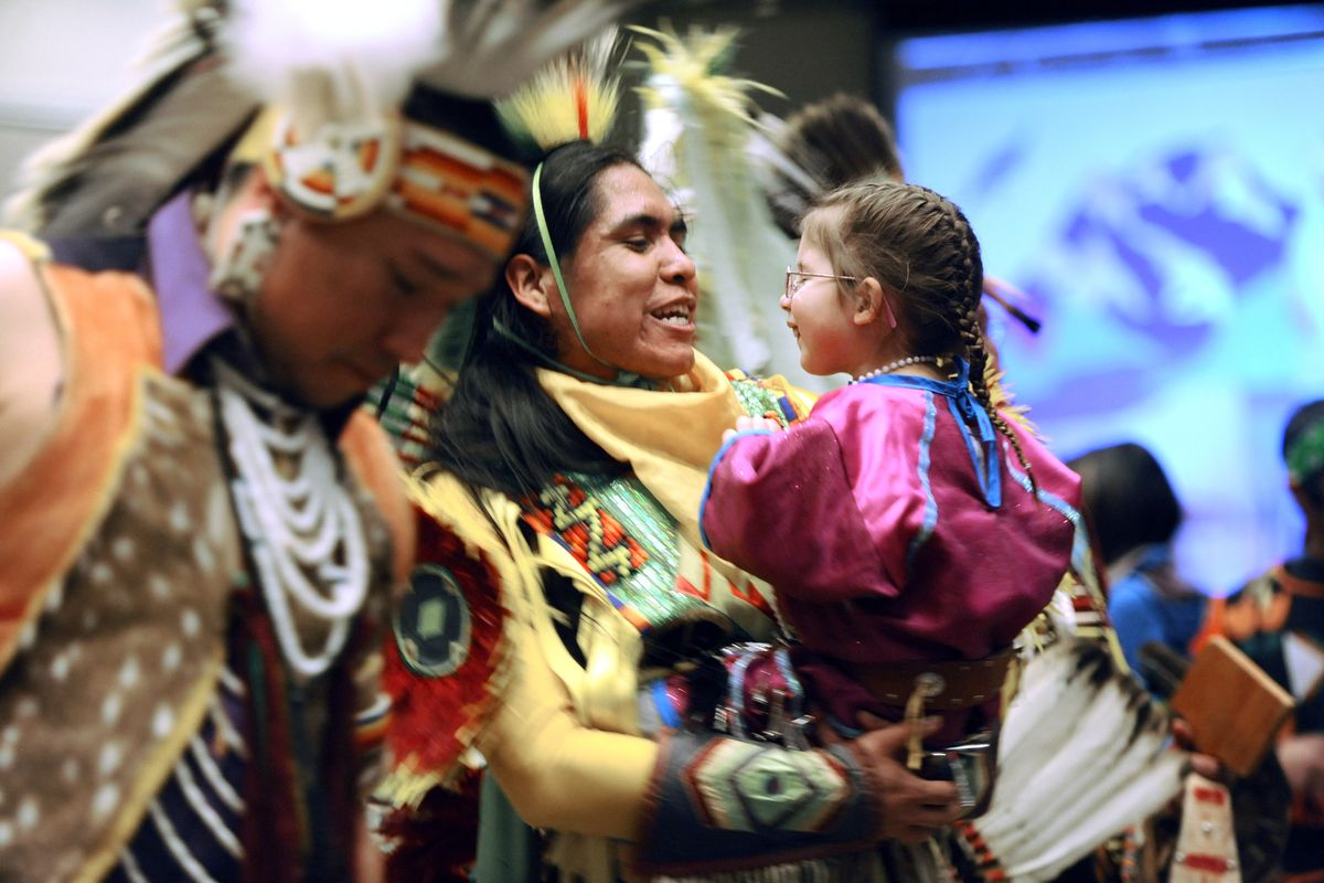 Lawrence McDonald, a Colville and Nez Perce Indian, chats with Kaienna Noel, 3, while dancing in the Celebrating Salish Conference powwow March 7 at Northern Quest Resort and Casino. The three-day conference focused on the revival of the Salish language. (Jesse Tinsley)