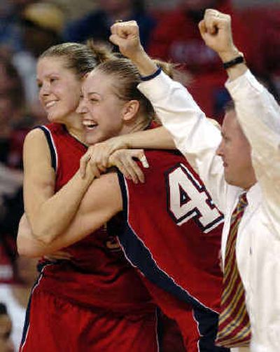 
Liberty's Rima Margeviciute, left, and Katie Feenstra, center, celebrate after their team's 88-79 upset of DePaul in a second-round NCAA Tournament game on Tuesday at College Park, Md. 
 (Associated Press / The Spokesman-Review)