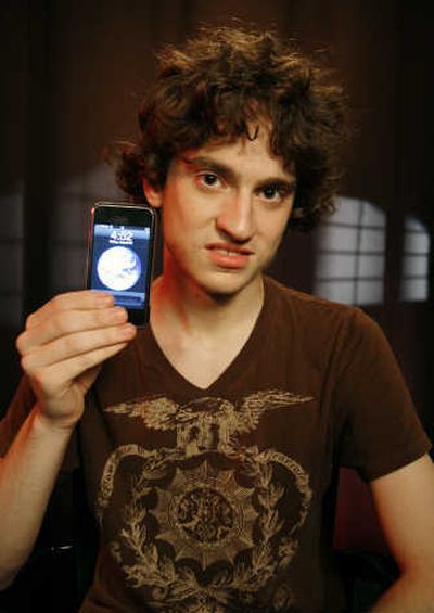 
George Hotz, 17, holds an iPhone that he has unlocked and is using on T-Mobile's network. Associated Press
 (Associated Press / The Spokesman-Review)
