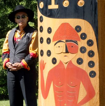 Suquamish tribal council member Bardow Lewis stands near one of the new wooden poles at the renovated grave site of Chief Seattle in Suquamish, Wash., on Saturday. (Associated Press)