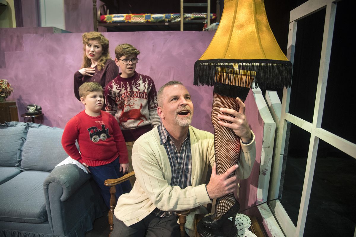 Mark Pleasant, as The Old Man, hugs his new leg lamp much to the displeasure of Tami Knoell, as Mother, Brody Else, as Randy, and Kevon Burget, as Ralphie, during a scene from Civic Theatre’s “A Christmas Story: The Musical.” (Dan Pelle / The Spokesman-Review)