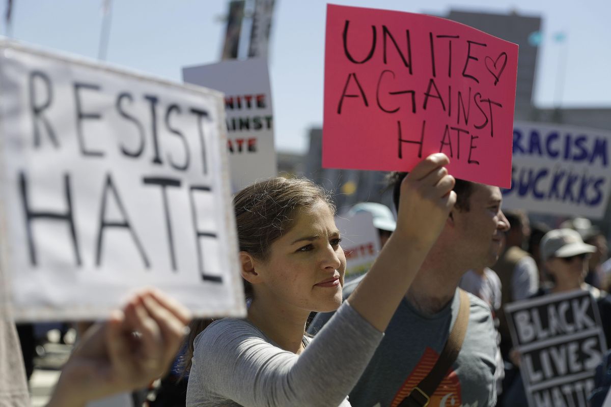 A woman holds up a sign at a rally in San Francisco, on Friday, ahead of politically conservative rallies scheduled this weekend. (Marcio Jose Sanchez / Associated Press)