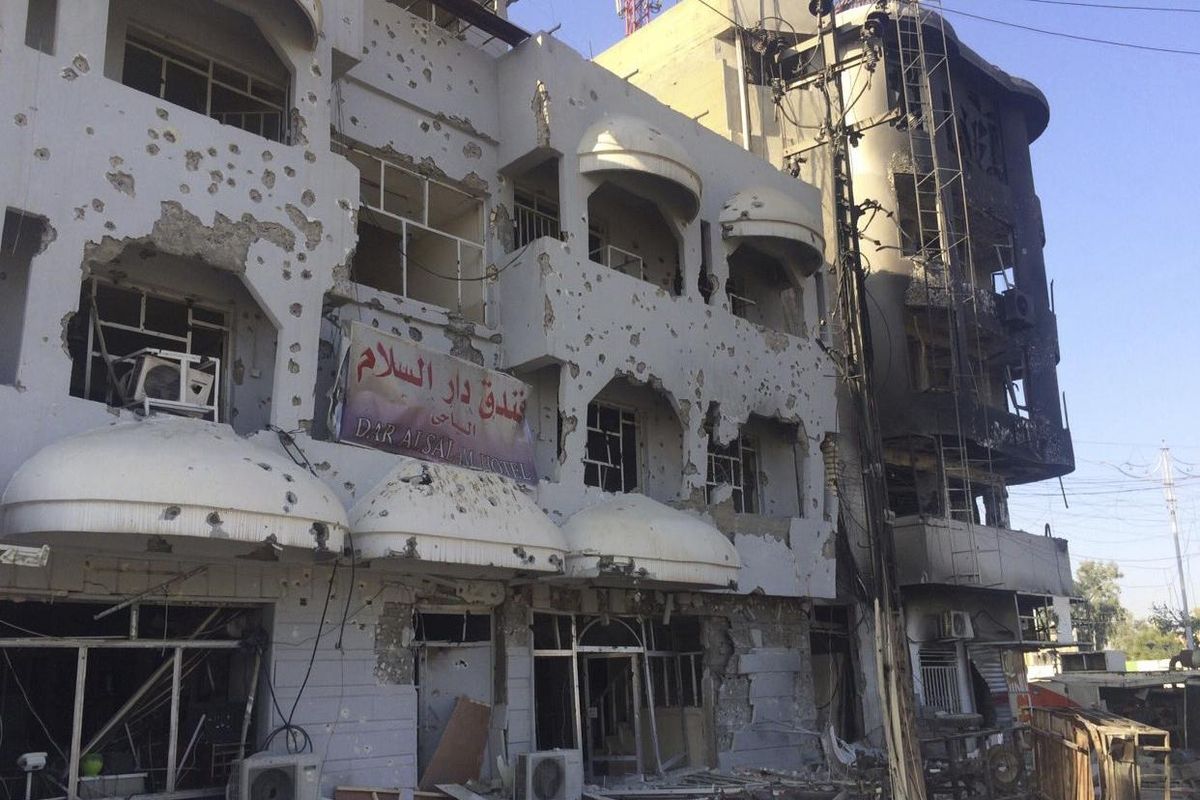 Buildings are damaged after clashes between Iraqi security forces and members the Islamic state in the city of Kirkuk, 180 miles north of Baghdad, Iraq, Saturday. (Uncredited / Associated Press)