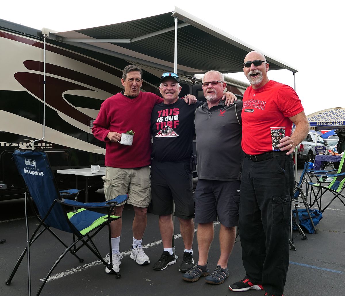 Members of the 1984 EWU baseball team - from left, Brian Snavely, Jim Wasem, Vern Yake and Steve Anderson - party before the opener against the Huskies Saturday in Seattle. (John Nelson)
