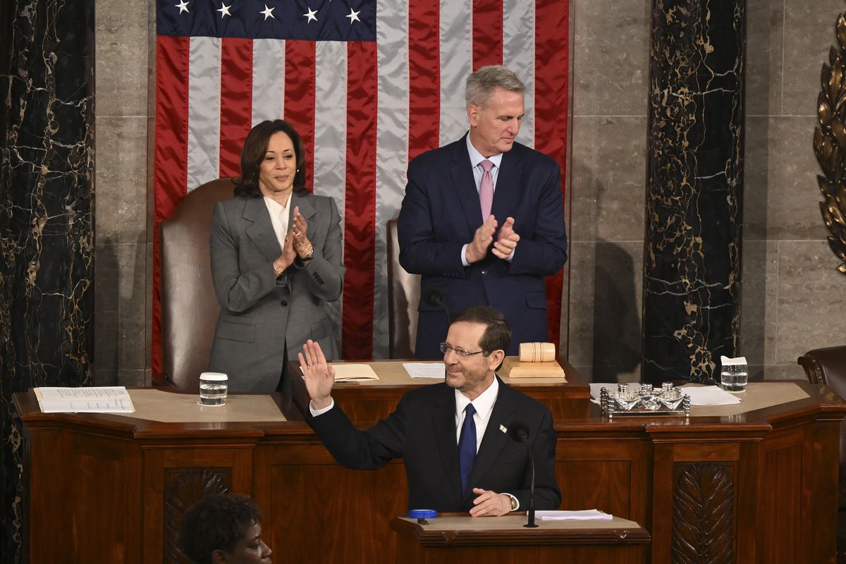 President Isaac Herzog of Israel addresses a joint meeting of Congress on Capitol Hill in Washington, July 19, 2023. Vice President Kamala Harris and House Speaker Kevin McCarthy (R-Calif.) applaud behind him.  (Kenny Holston/The New York Times)