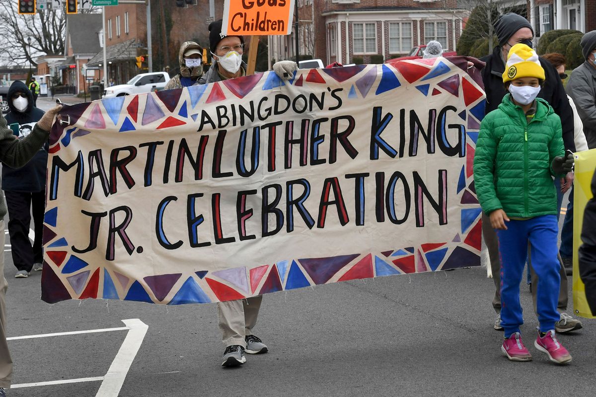 People walk during the annual Martin Luther King Jr. celebration and march, Saturday, Jan. 15, 2022, in Abingdon, Va. After a ceremony at the Farmers Market pavilion, those in attendance marched down Main Street to St. Thomas Episcopal Church.  (David Crigger)