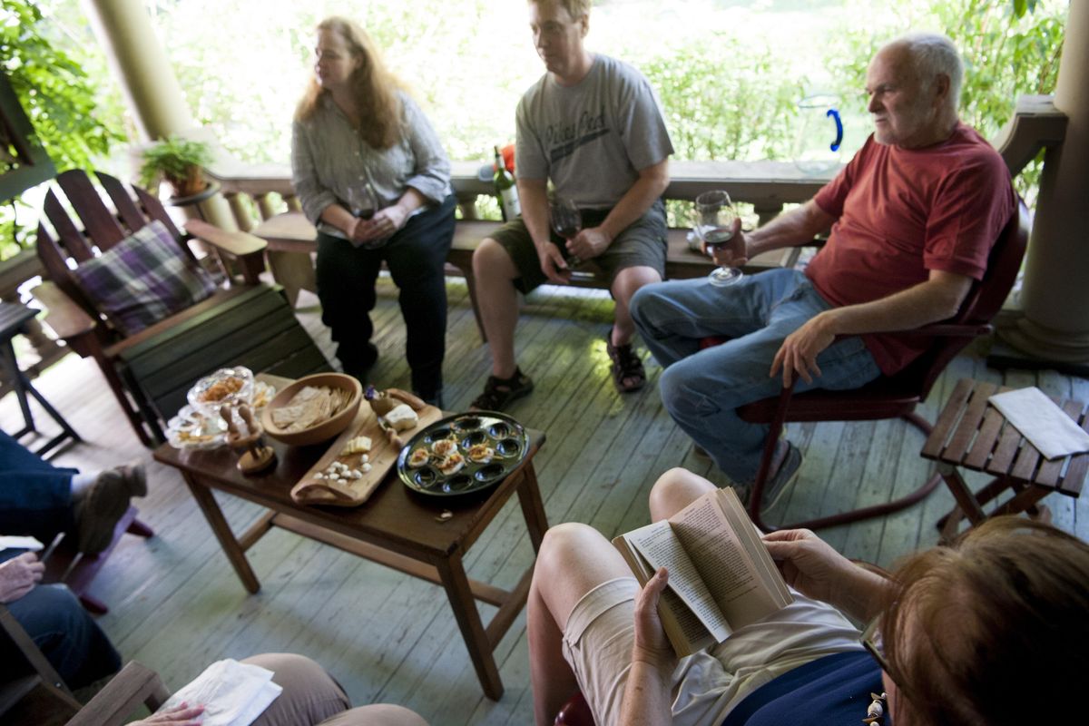 Book club members, from upper left, Beverly and Brian Anderson, Ray Emerson and Aubra Pollack discuss “Earth Abides,” a 1949 post-apocalyptic novel by George R. Stewart on Aug. 4, 2016, in Spokane, Wash. (Tyler Tjomsland / The Spokesman-Review)