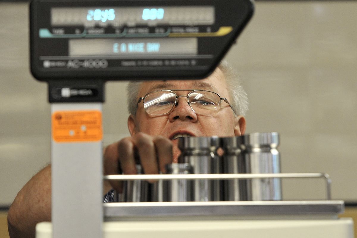 Steve Parker, of the city of Spokane Weights and Measures Department, tests a newly installed scale for accuracy at the Super 1 Foods meat counter on Oct. 11. The scale tested near perfect. Budget cuts in 2004 left Parker as the department’s only employee. (Dan Pelle)