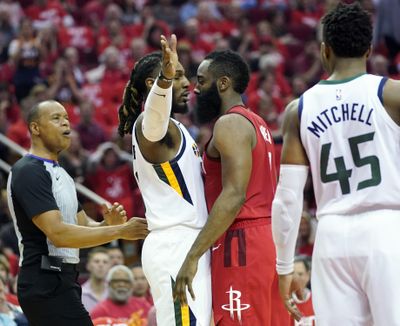 Utah Jazz forward Jae Crowder, center left, and Houston Rockets guard James Harden, center right, come face to face during the first half in Game 5 of an NBA basketball playoff series, in Houston, Wednesday, April 24, 2019. (David J. Phillip / Associated Press)