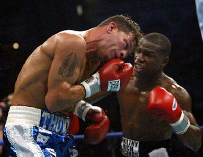 
Floyd Mayweather Jr., right, punishes Arturo Gatti in second-round action of their title fight. 
 (Associated Press / The Spokesman-Review)