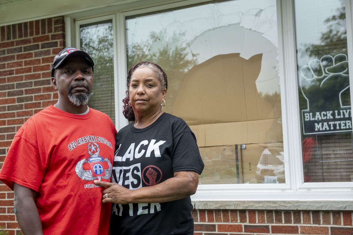 Eddie Hall Jr. and his wife Candace stand in front of the broken front window of their Warren, Mich., home, on Thursday, Sept. 10, 2020. Some experts say political and social unrest as well as the coronavirus pandemic has taken a disproportionate physical and financial tolls on Black people, resulting in increased anxiety levels among African Americans.  (David Guralnick)