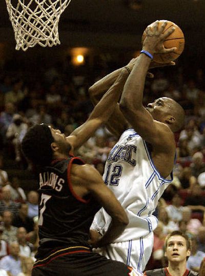 
Orlando's Dwight Howard is fouled by Philadelphia's John Salmons on Saturday night in Orlando, Fla.
 (Associated Press / The Spokesman-Review)