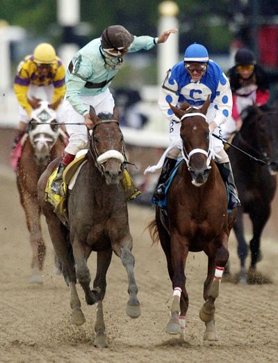 Jockey Edgar S. Prado, left, aboard Birdstone, reacts after winning the 2004 Belmont Stakes as jockey Stewart Elliott, right, aboard Smarty Jones, watches at the finish. (Associated Press)