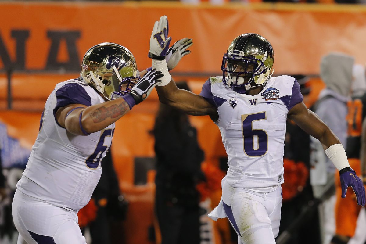 Washington running back Deontae Cooper, right, lost the first three years of his college career to torn ACLs. (Associated Press)