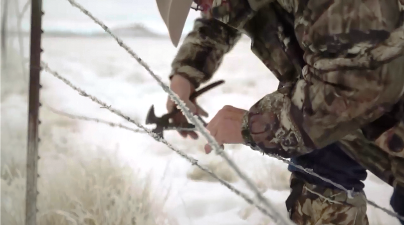 An anti-government protester cuts a fence during a takeover of the Malheur National Wildlife Refuge in Oregon.