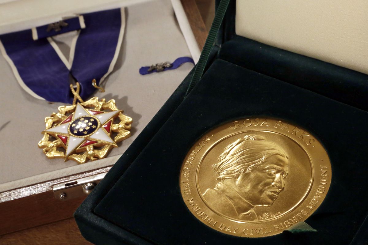 From left, Rosa Parks’ Presidential Medal of Freedom and Congressional Gold Medal, a rosary, a New Testament and an address book are displayed at a New York auction house. (Associated Press)