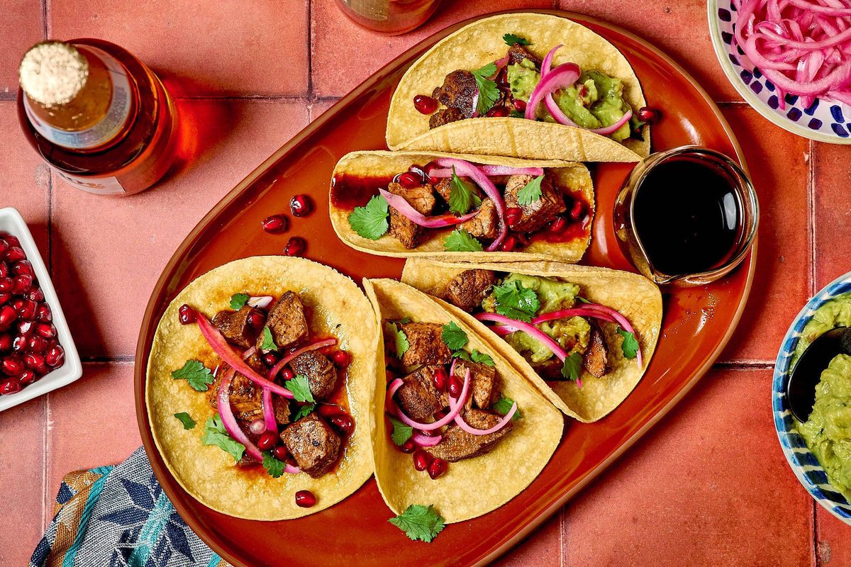 Pork Tenderloin Tacos With Pomegranate and Chile from Bobby Flay’s latest cookbook.  (Peggy Cormary for The Washington Post/Food styling by Carolyn Robb for The Washington Post)