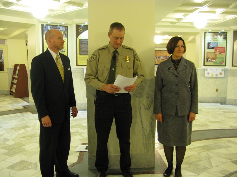 Adams County Sheriff Ryan Zollman, center, endorses the guns on campus bill Wednesday; at left is bill sponsor Sen. Curt McKenzie, and at right, co-sponsor Rep. Judy Boyle. (Betsy Russell)