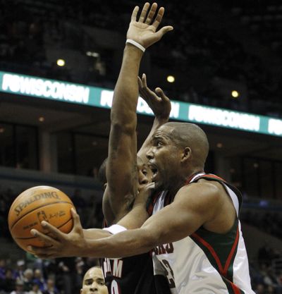 Milwaukee’s Michael Redd drives to the basket as Portland’s Dante Cunningham defends during the Bucks’ double-OT win.  (Associated Press)