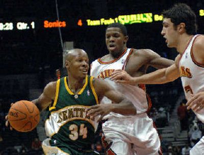 
Seattle's Ray Allen drives on Atlanta's Joe Johnson, center, and Zaza Pachulia during the first quarter. 
 (Associated Press / The Spokesman-Review)