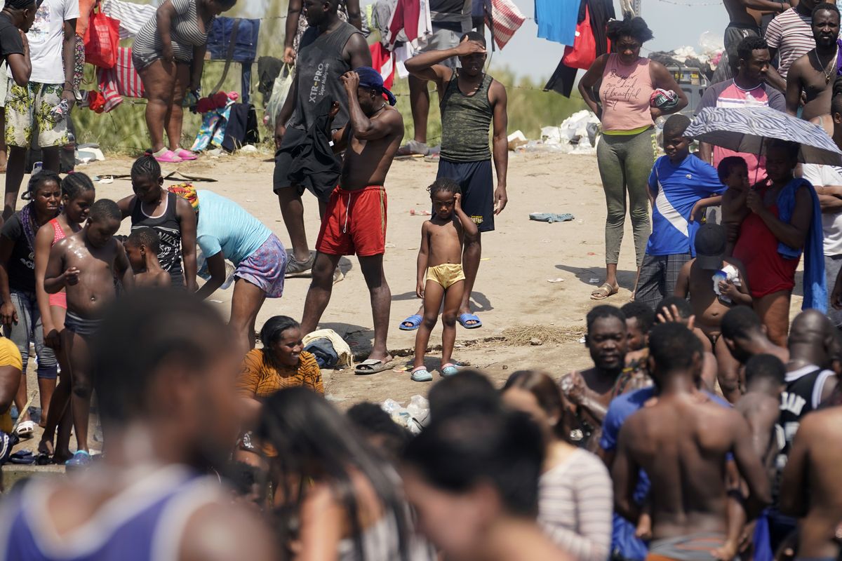 Haitian migrants gather on the banks of the Rio Grande after they crossed into the United States from Mexico on Saturday in Del Rio, Texas.  (Eric Gay)