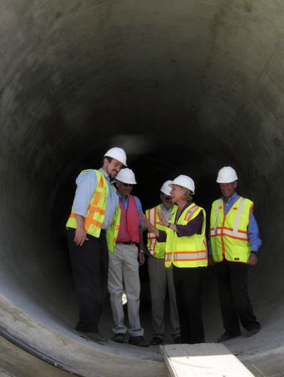 Gov. Chris Gregoire, second from right, gestures to other state and federal officials while reviewing a new irrigation canal east of Moses Lake on Tuesday. (Associated Press)