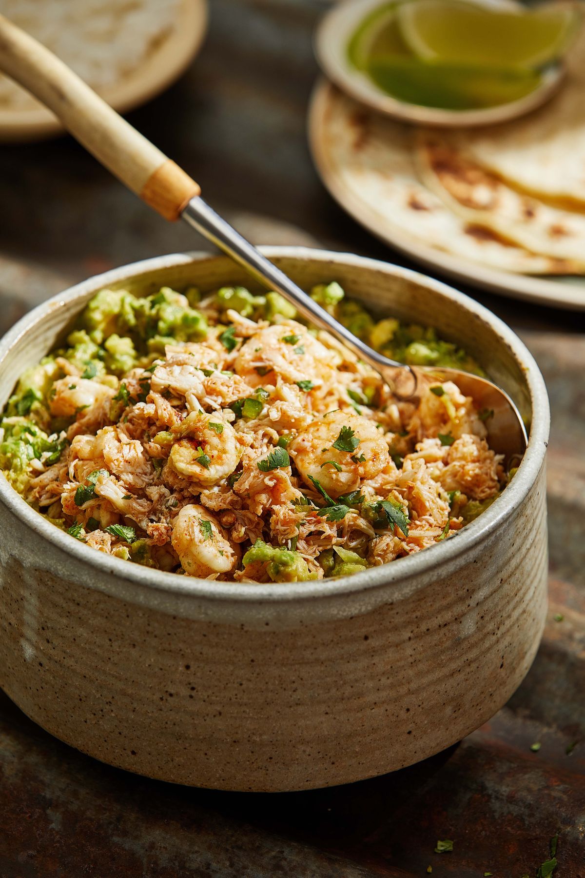 In this recipe, seafood (shrimp and crab) is stirred into guacamole for a weeknight dinner.  (Tom McCorkle/For the Washington Post)