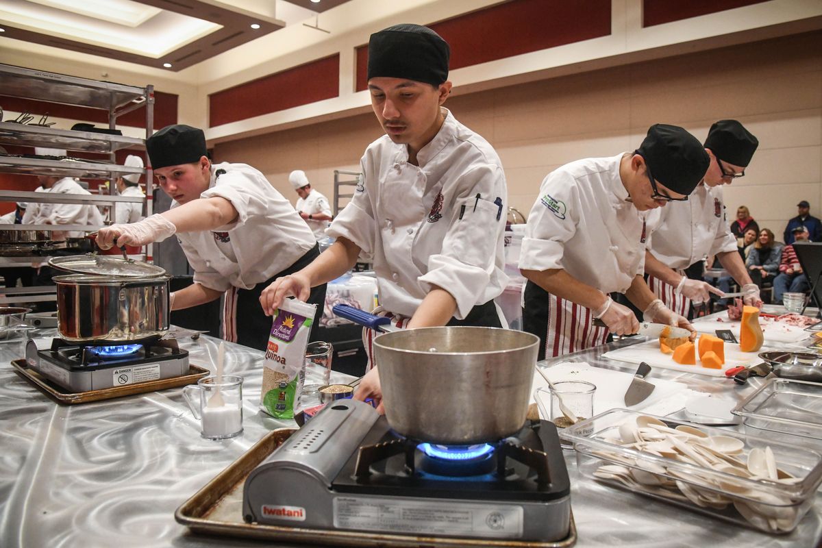 Ferris High School student chefs, from left, Maya Watson, Brandon Hawotte, Adam Nyuyen and Caleb Stackwell prepare a dinner of pan seared scallops, herb crusted lamb and raspberry chocolate truffles at the ProStart Invitational, Saturday, March 2, 2019, at the Davenport Grand Hotel. (Dan Pelle / The Spokesman-Review)