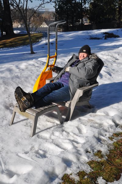 Pat Munts settled in for a few minutes of basking in the warm sun after chipping ice off her shady driveway proved a lost cause.  (Steve Munts/For The Spokesman-Review)