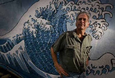 
 Tsusami Books co-owner Scott Landfield stands next to the mural above the front entrance depicting a crashing wave in Eugene, Ore. In the weeks since the Indian Ocean tsunami, Landfield has seen his bookstore's online sales quadruple. 
 (Associated Press / The Spokesman-Review)