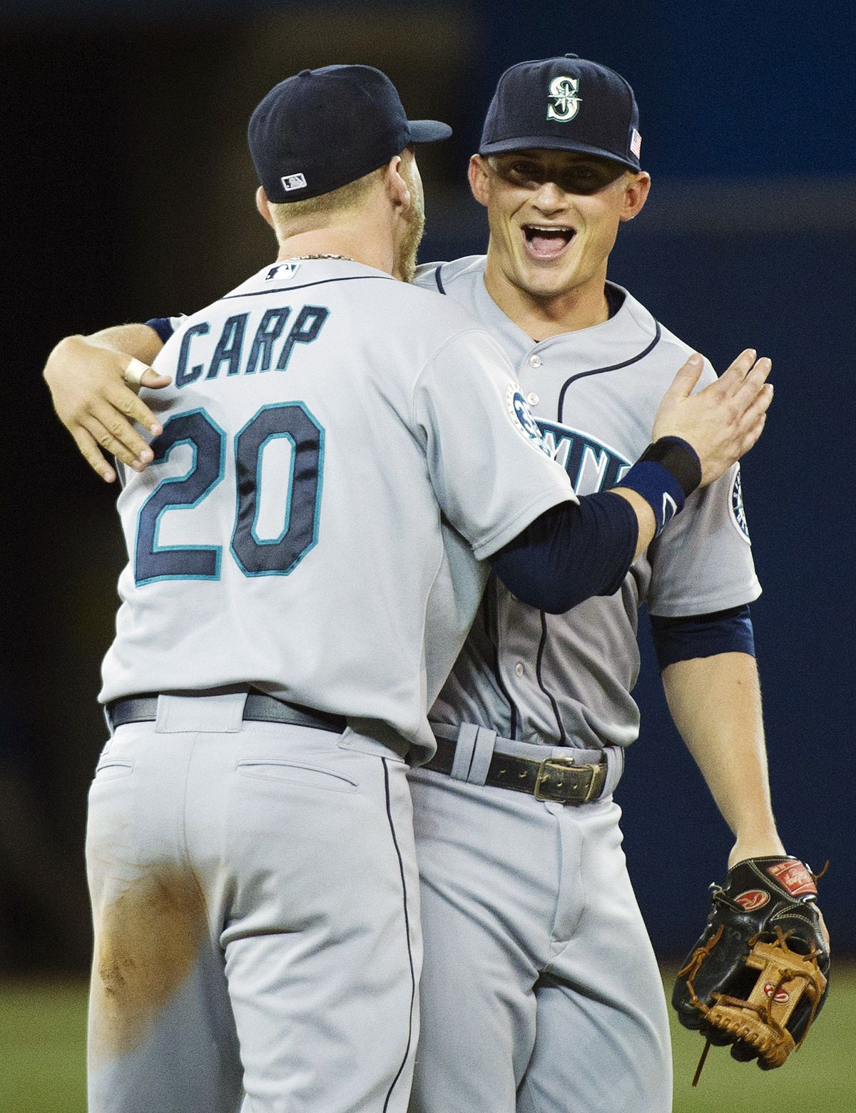 Mariners Mike Carp and Kyle Seager celebrate beating the Blue Jays. Seager was a triple away from hitting for the cycle. (Associated Press)