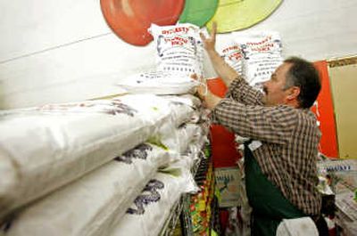 
Christos Angelopoulos, manager of 22nd & Irving Market, stacks bags of jasmine rice last week in San Francisco. Associated Press
 (Associated Press / The Spokesman-Review)