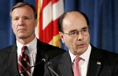 
James B. Lockhart III, acting director of the Office of Federal Housing Enterprise Oversight, right, and Security and Exchange Commission Chairman Christopher Cox discuss the Fannie Mae report.
 (Associated Press / The Spokesman-Review)
