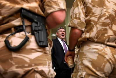 British Prime Minister Gordon Brown talks to British troops at Basra Air Base in southern Iraq during his visit Wednesday.  He  said the British mission in Iraq will end no later than May 31, 2009.  (Associated Press / The Spokesman-Review)