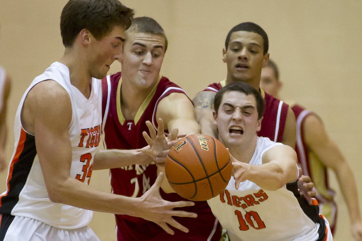 LC’s Austin Damon (left) and teammate Jeff Livingston reach for ball, as do U-Hi’s Conner Johnson (second from left) and Zane McDonald. (Colin Mulvany)